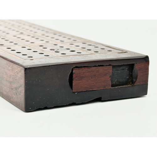 178 - A 19th Century rosewood cribbage board. 27.5x7.5x2.5cm