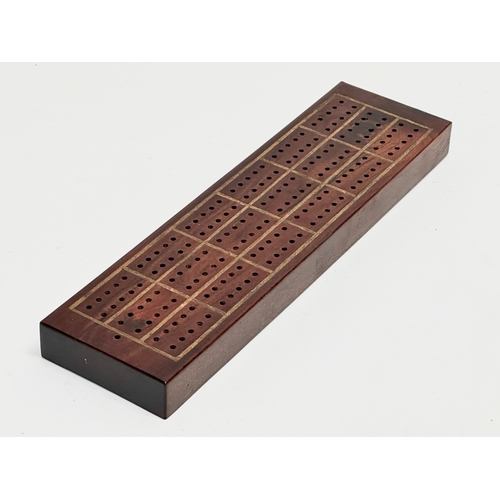 178 - A 19th Century rosewood cribbage board. 27.5x7.5x2.5cm