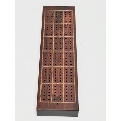 178 - A 19th Century rosewood cribbage board. 27.5x7.5x2.5cm