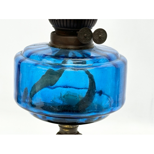 182 - A Late 19th Century Victorian oil lamp with Bristol Blue bowl and gilt cast iron base. 54cm