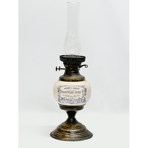 33 - A Early 20th Century ceramic ‘Hatchet & Gimlet’s’ Fashionable Hardware Store advertising oil lamp.