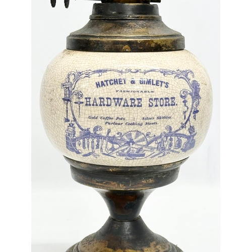 33 - A Early 20th Century ceramic ‘Hatchet & Gimlet’s’ Fashionable Hardware Store advertising oil lamp.