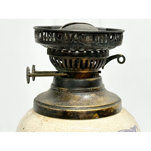 33 - A Early 20th Century ceramic ‘Hatchet & Gimlet’s’ Fashionable Hardware Store advertising oil lamp.