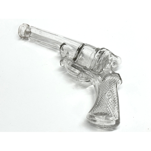 185 - A pair of Early 20th Century glass revolver pistol bottles. 25cm