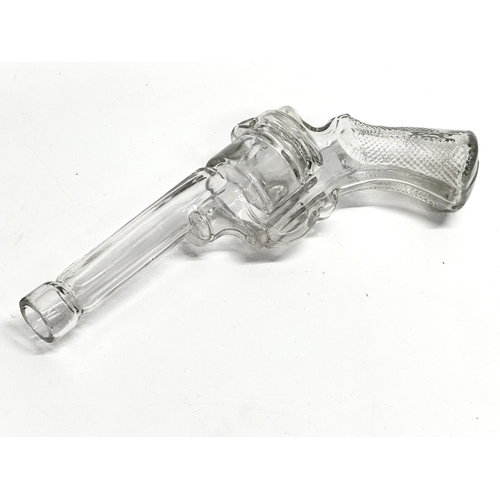 185 - A pair of Early 20th Century glass revolver pistol bottles. 25cm