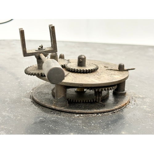 35 - A large Late 19th Century enamelled industrial clock face with works. 61cm