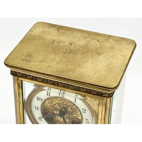 36 - A large Late 19th Century French brass mantle clock with 4 bevelled glass panels and mercury pendulu... 