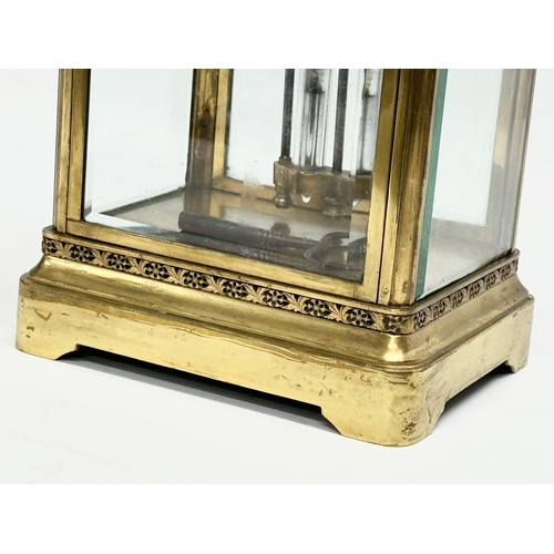 36 - A large Late 19th Century French brass mantle clock with 4 bevelled glass panels and mercury pendulu... 