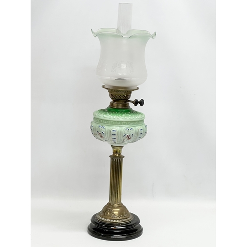 37 - A large Victorian double burner oil lamp with reeded brass column and later shade. 71cm