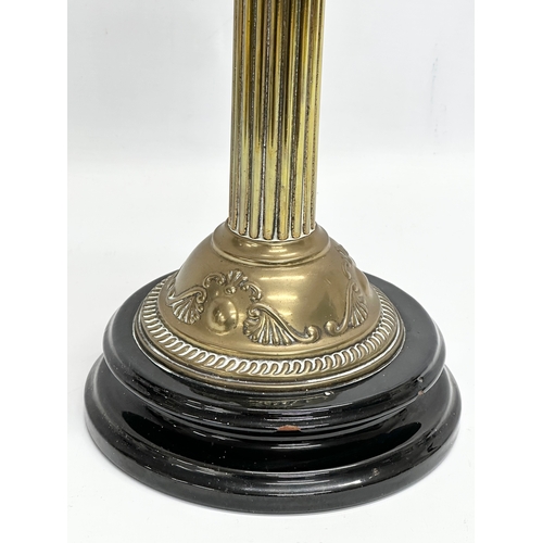 37 - A large Victorian double burner oil lamp with reeded brass column and later shade. 71cm