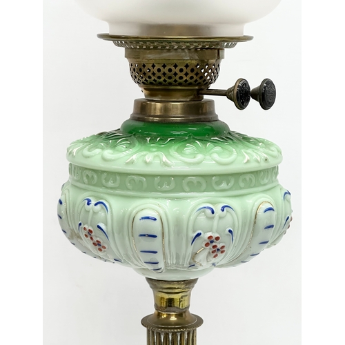 37 - A large Victorian double burner oil lamp with reeded brass column and later shade. 71cm