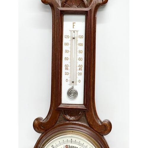 247 - An Early 20th Century oak barometer. Circa 1900. 76cm