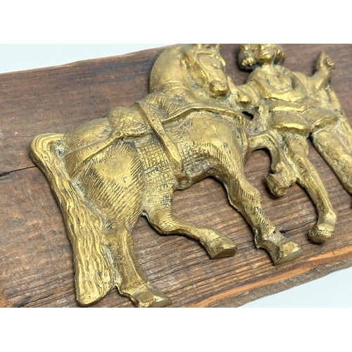 263 - A Late 19th/Early 20th Century brass wall plaque. 28x17cm