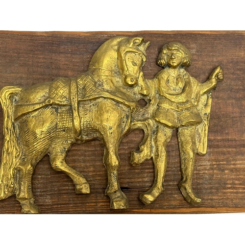 263 - A Late 19th/Early 20th Century brass wall plaque. 28x17cm