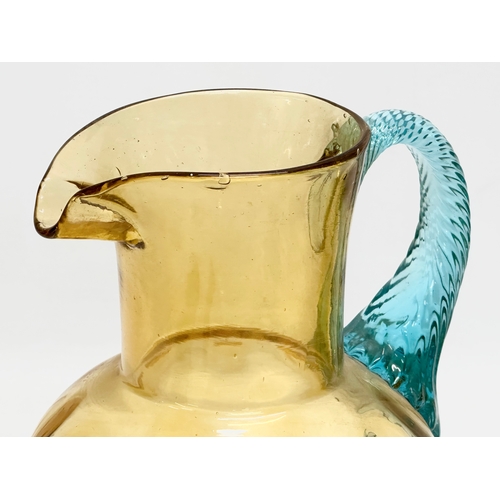 273 - A Late 19th/Early 20th Century George Sand Portieux amber glass water jug with turned turquoise hand... 