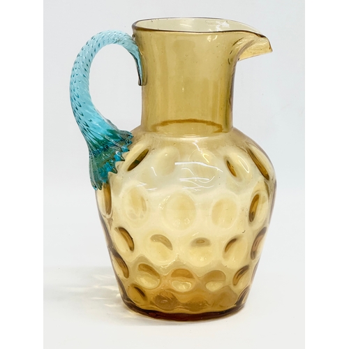 273 - A Late 19th/Early 20th Century George Sand Portieux amber glass water jug with turned turquoise hand... 