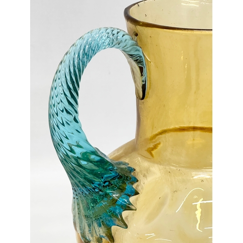 273 - A Late 19th/Early 20th Century George Sand Portieux amber glass water jug with turned turquoise hand... 