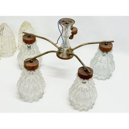 302 - A Mid Century teak and brass ceiling light with glass shades. 48x31cm