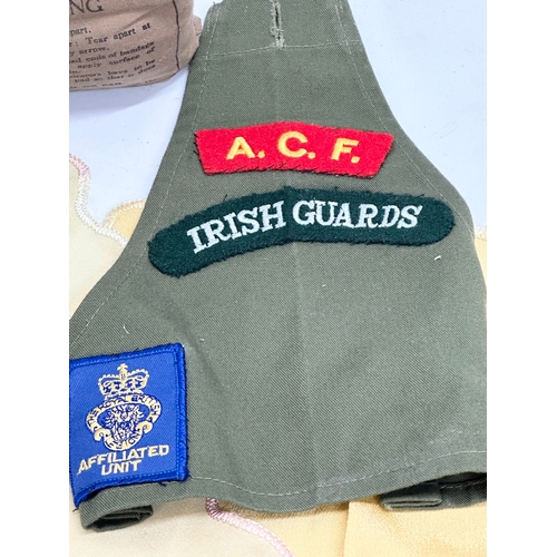 303 - A collection of British Militaria. An Irish Guards Affiliated Unit armband. 2 Royal Air Force silks.... 