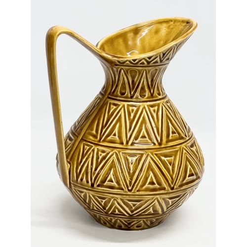 571 - A large Irish glazed pottery jug by Celtic Ceramics. 23x20x28cm