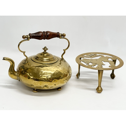 569 - A Victorian brass kettle and later stand.