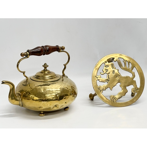 569 - A Victorian brass kettle and later stand.