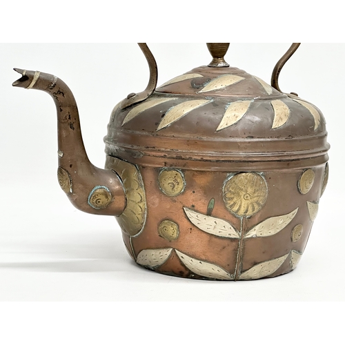 290 - A Late 19th Century Indian copper kettle with brass foliage. 25x17x23cm