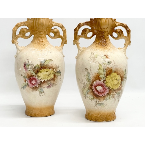 331 - A pair of large hand painted pottery vases. Circa 1890-1910. 35cm