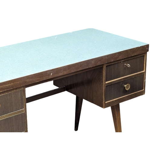 1038 - A Mid Century desk. 130x56x74.5cm