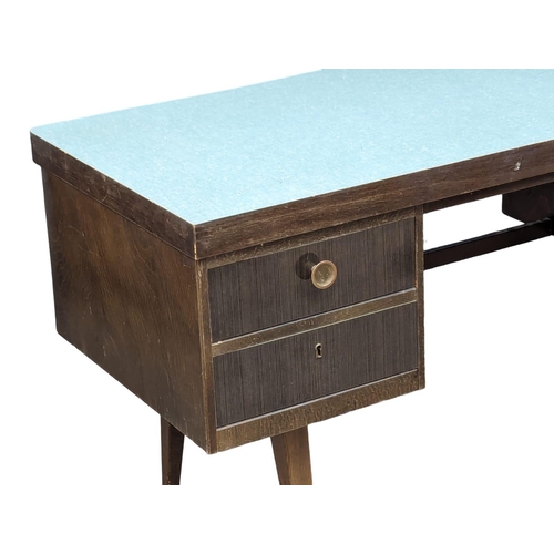 1038 - A Mid Century desk. 130x56x74.5cm