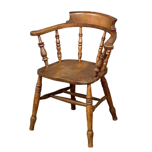 827 - A Victorian elm and beech elbow chair/armchair.