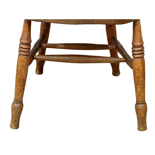 827 - A Victorian elm and beech elbow chair/armchair.