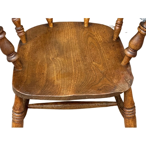 827 - A Victorian elm and beech elbow chair/armchair.