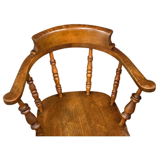 827 - A Victorian elm and beech elbow chair/armchair.