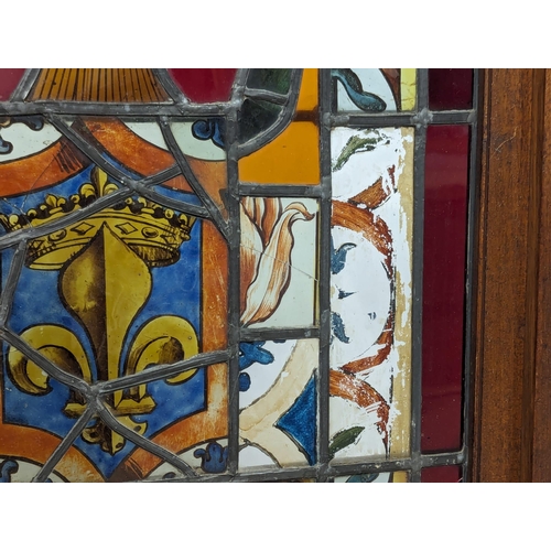 831 - An Edwardian mahogany stained glass fire screen. 53x102cm