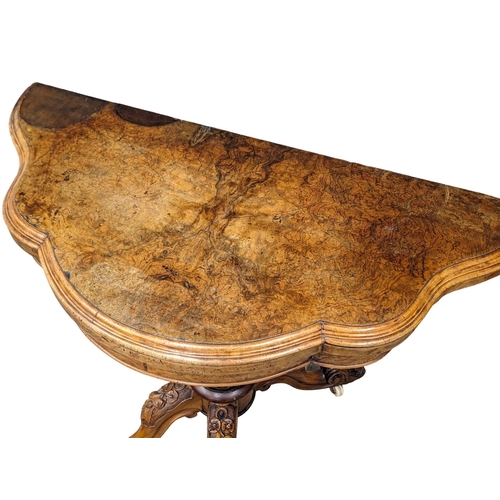 853 - A Victorian burr walnut turnover games table. 102x49x74.5cm