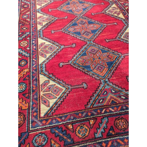 863 - A large 'Karijan' Middle Eastern hand knotted runner / rug. 259x99cm