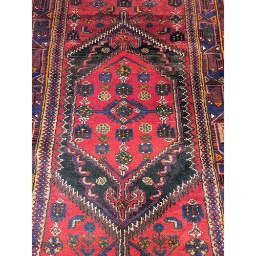 864 - A Middle Eastern hand knotted rug. 212x127cm