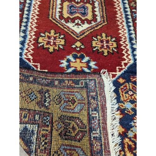 866 - A vintage Middle Eastern hand knotted rug. 96x196cm