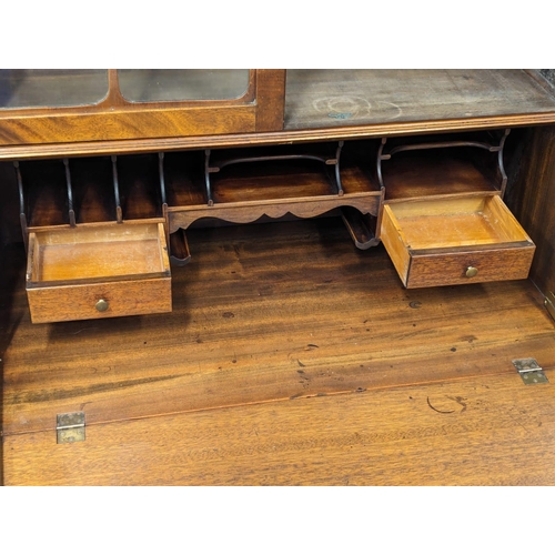 887 - An Early 20th Century on mahogany Chippendale style bureau bookcase on Cabriole legs and Ball & Claw... 