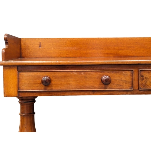 979 - An Early Victorian mahogany gallery back side table with 2 drawers. 110x53.5x87.5cm