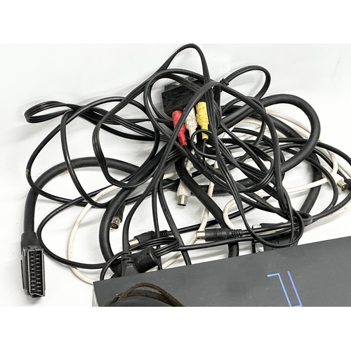 570 - A PS2 (PlayStation 2) console with 3 controllers.