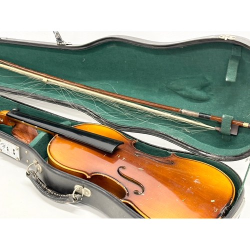 593 - A violin in case.