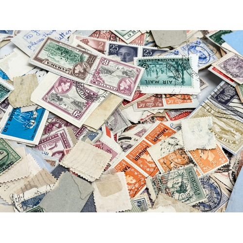 597 - A large collection of stamps. British, Canadian, Italian, India etc