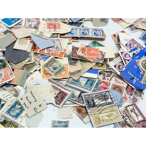 597 - A large collection of stamps. British, Canadian, Italian, India etc