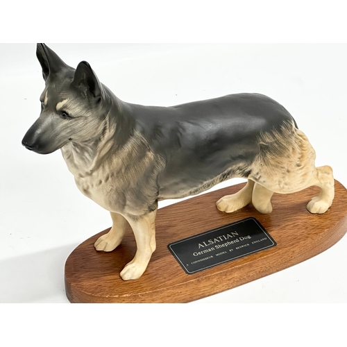 613 - A Beswick pottery Alsatian German Shepherd Dog on stand. 25x22cm