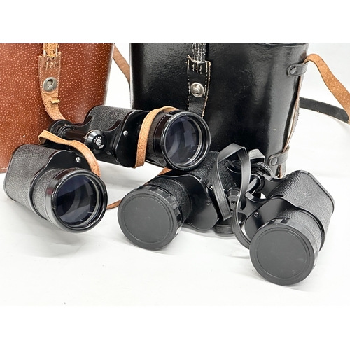 615 - 2 pairs of binoculars with cases.