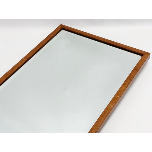 356 - A long Rowley Products Mid Century teak framed bevelled mirror. 33x94cm.