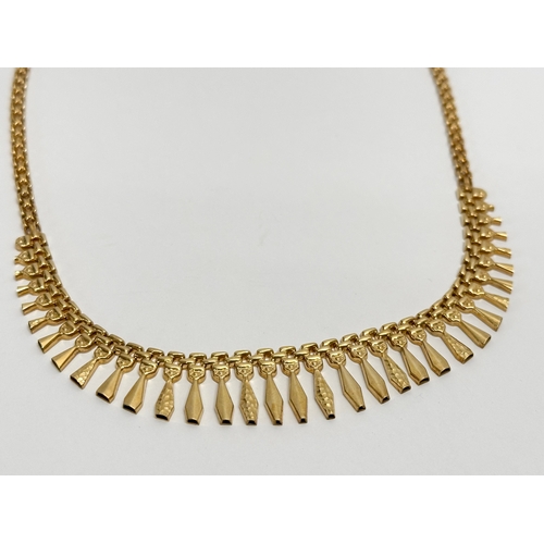 461D - A 9ct gold Egyptian style ladies necklace. 10.9 grams.