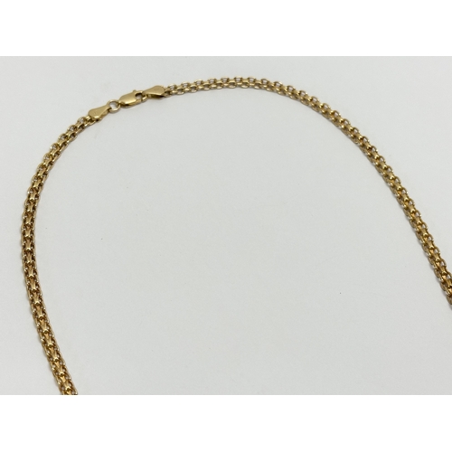 461D - A 9ct gold Egyptian style ladies necklace. 10.9 grams.